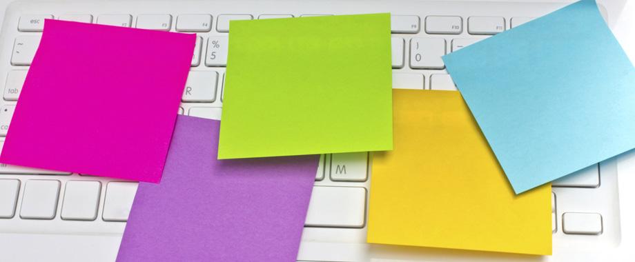 Colorful sticky notes post on white  laptop's keyboard